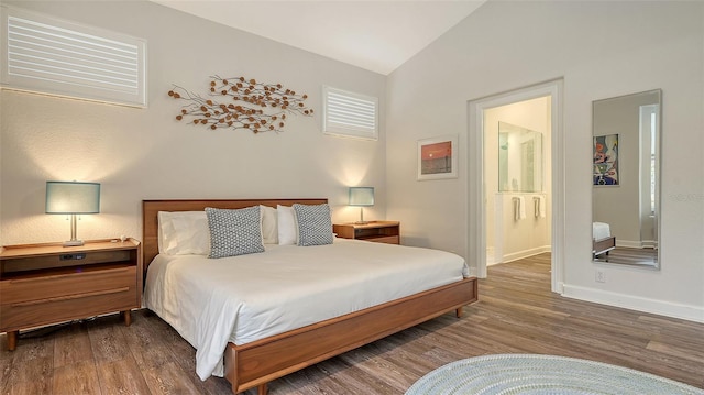 bedroom featuring lofted ceiling and hardwood / wood-style floors