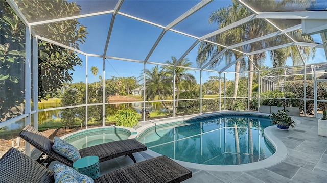 view of pool featuring an in ground hot tub, a lanai, a water view, and a patio area