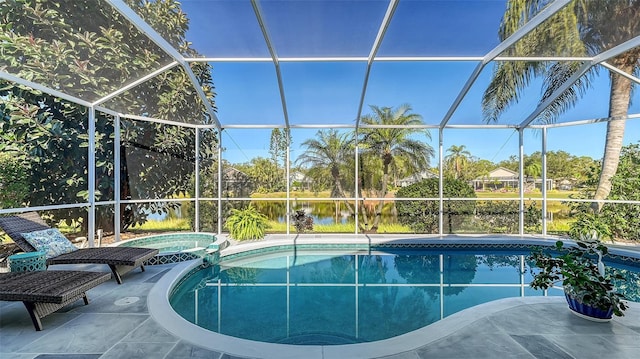 view of swimming pool with a lanai, a patio area, a water view, and an in ground hot tub