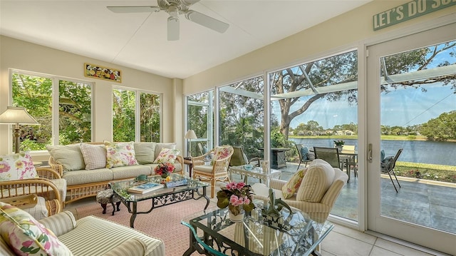 sunroom featuring ceiling fan, a water view, and a healthy amount of sunlight