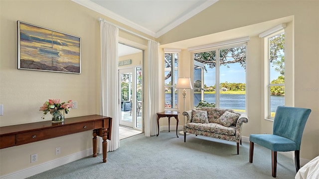 living area with a healthy amount of sunlight, crown molding, light colored carpet, and vaulted ceiling