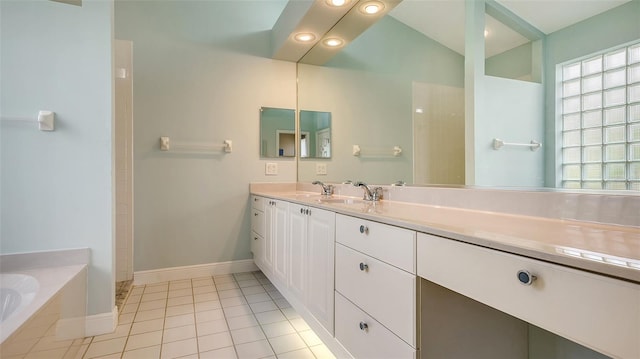 bathroom featuring tile patterned floors, a bathing tub, and vanity