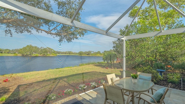 sunroom featuring plenty of natural light and a water view