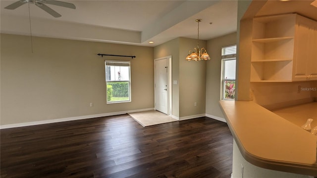 entrance foyer featuring dark wood-type flooring and ceiling fan with notable chandelier