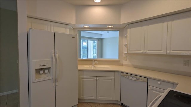 kitchen featuring light tile patterned floors, white appliances, white cabinetry, and sink