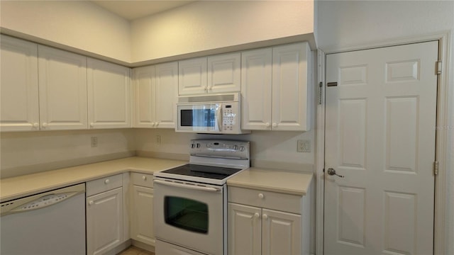 kitchen with white appliances and white cabinetry