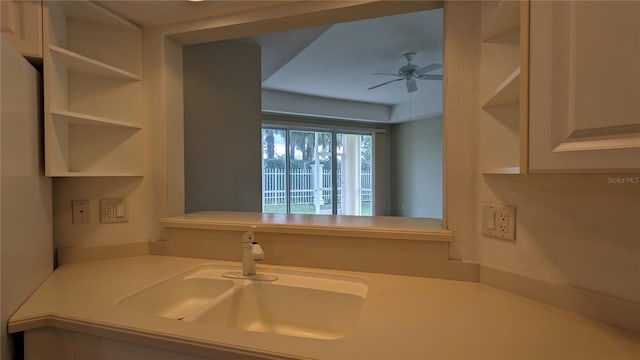 kitchen featuring ceiling fan and sink