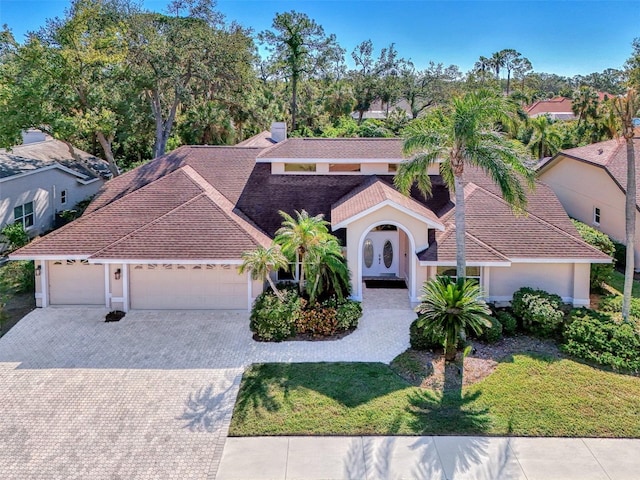 view of front facade with a garage and a front lawn