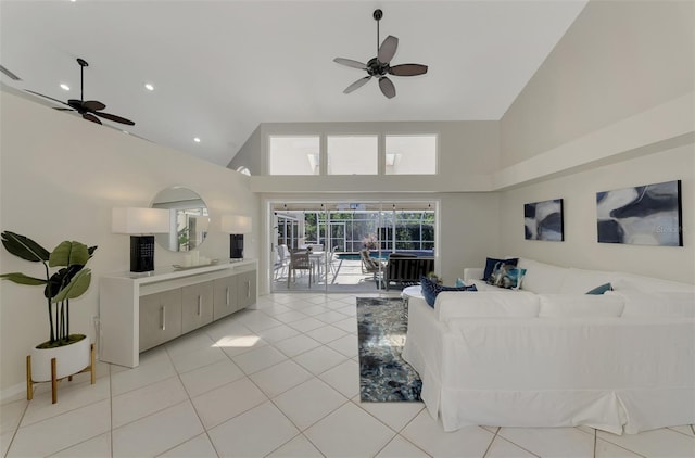 living room featuring ceiling fan, light tile patterned floors, and high vaulted ceiling