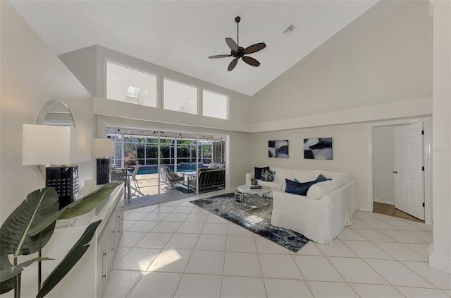 tiled living room with high vaulted ceiling and ceiling fan