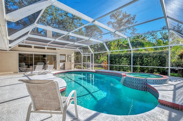 view of pool with glass enclosure, a patio area, and an in ground hot tub