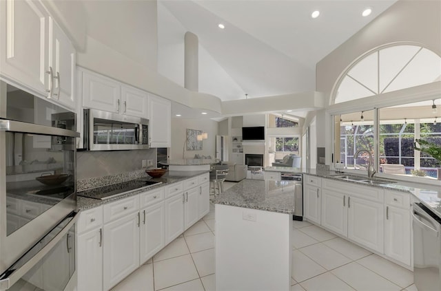 kitchen with a kitchen island, white cabinetry, and stainless steel appliances