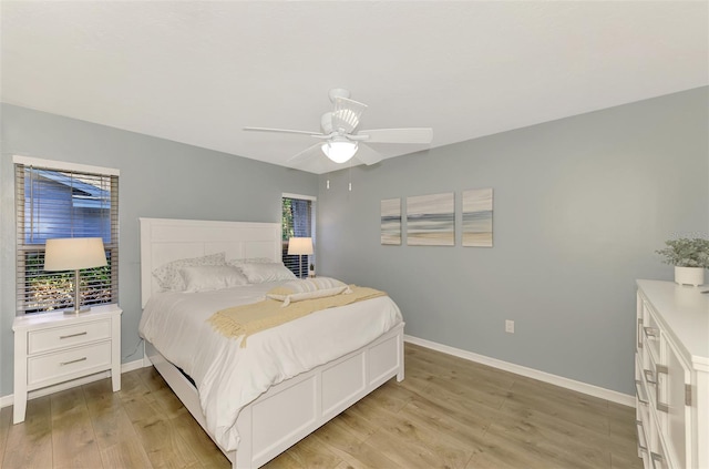 bedroom with light hardwood / wood-style floors and ceiling fan