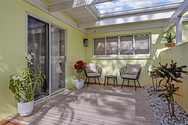 sunroom featuring beam ceiling