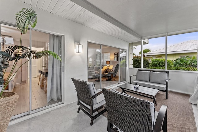 sunroom featuring beam ceiling