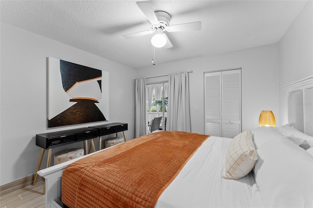 bedroom featuring ceiling fan, a textured ceiling, a closet, and light hardwood / wood-style flooring