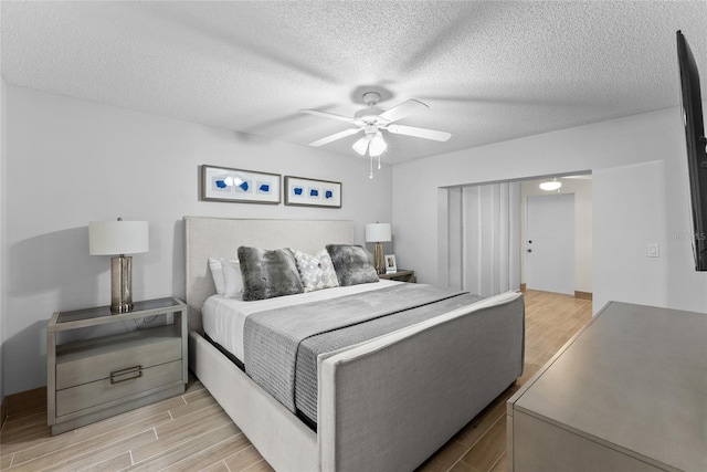 bedroom featuring a textured ceiling and ceiling fan