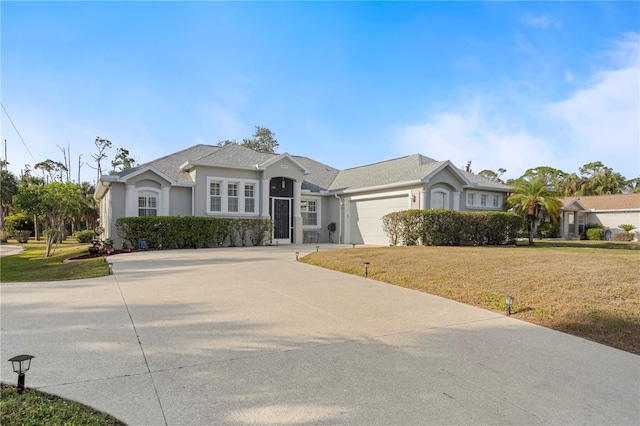 ranch-style home with a garage and a front yard