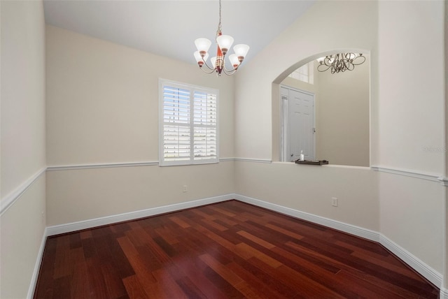 unfurnished room with vaulted ceiling, dark wood-type flooring, and a chandelier