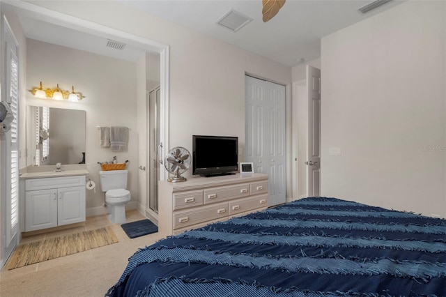 bedroom featuring ensuite bathroom, sink, and a closet