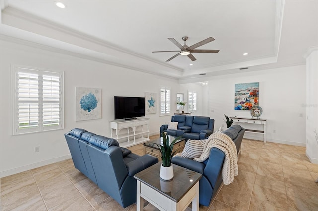 living room featuring a tray ceiling, crown molding, ceiling fan, and light tile patterned flooring