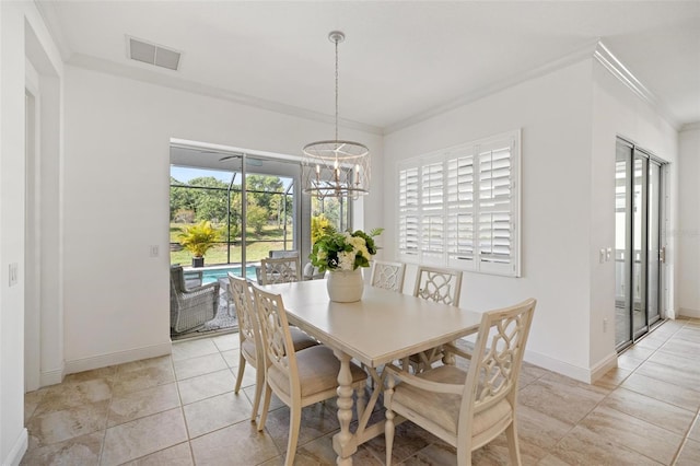 dining room featuring light tile patterned floors, ornamental molding, and a notable chandelier