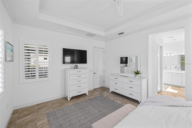 tiled bedroom with a tray ceiling, ensuite bath, ceiling fan, and crown molding