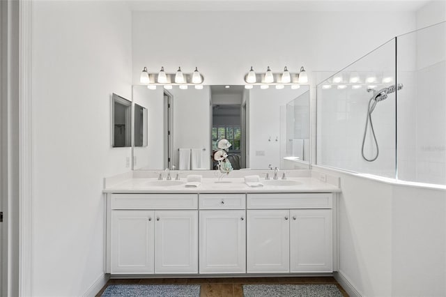 bathroom with vanity and a shower