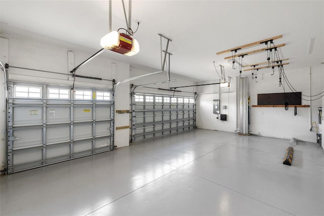 garage featuring electric panel and a garage door opener