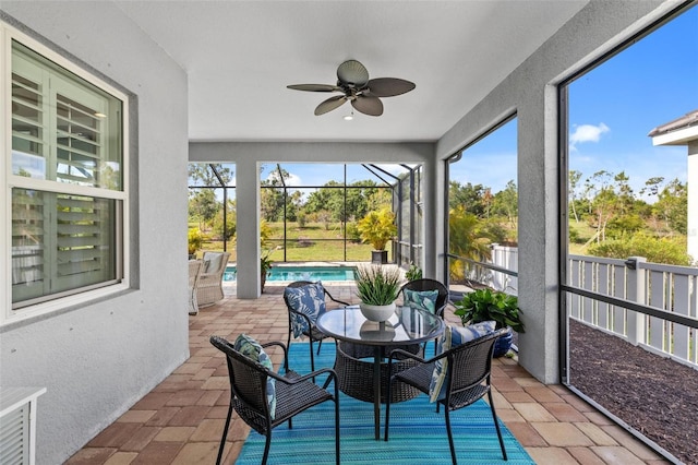 sunroom with ceiling fan and plenty of natural light