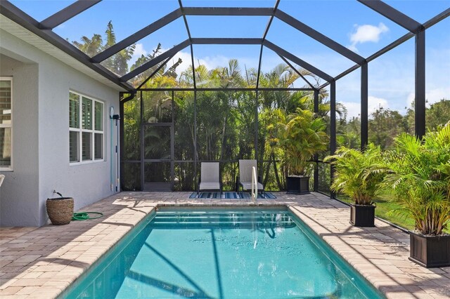 view of pool featuring a patio area and a lanai