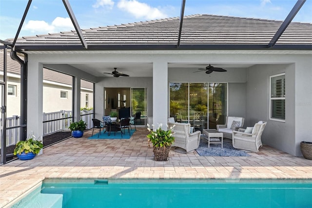 view of swimming pool with outdoor lounge area, a patio, and ceiling fan