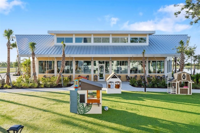 rear view of property featuring a lawn