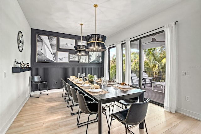 dining room with light hardwood / wood-style floors and a notable chandelier