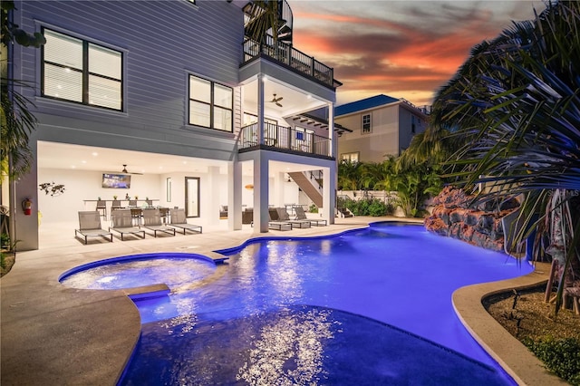 view of swimming pool featuring ceiling fan and a patio area