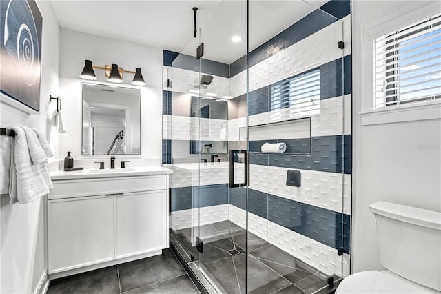 bathroom with toilet, an enclosed shower, and vanity