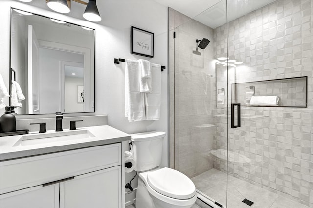 bathroom featuring vanity, an enclosed shower, and toilet