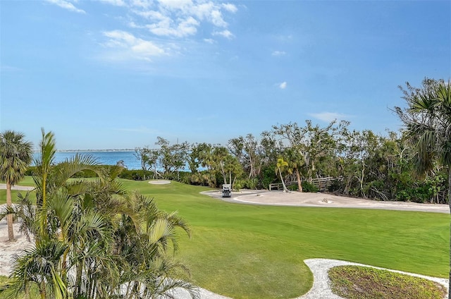 view of property's community featuring a yard and a water view