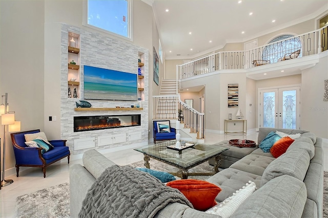 living room with ornamental molding, a fireplace, a high ceiling, and french doors