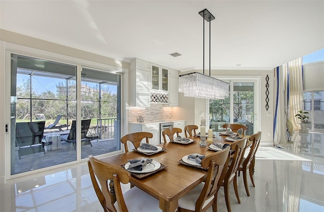 tiled dining space featuring a notable chandelier