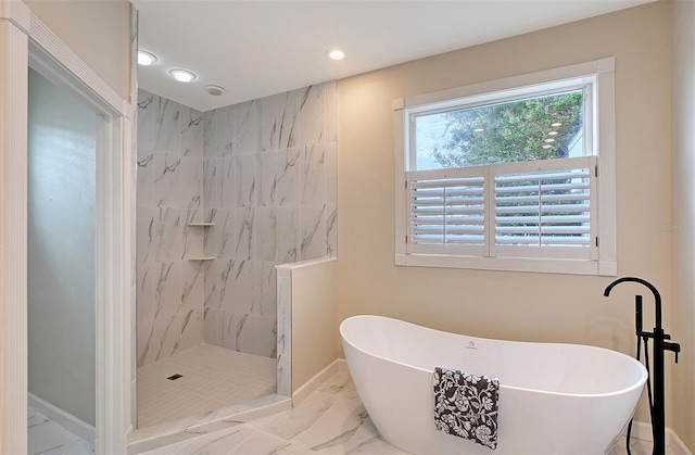 bathroom featuring independent shower and bath