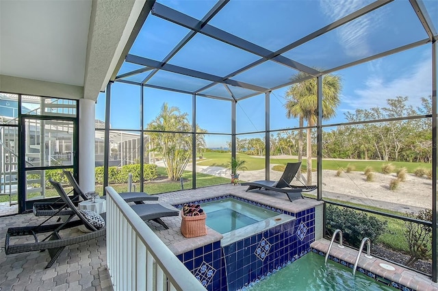 view of pool featuring an in ground hot tub and glass enclosure