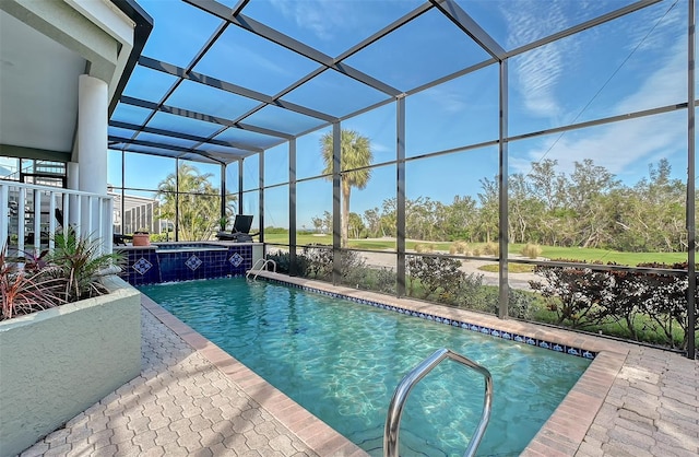 view of swimming pool with a lanai and a patio