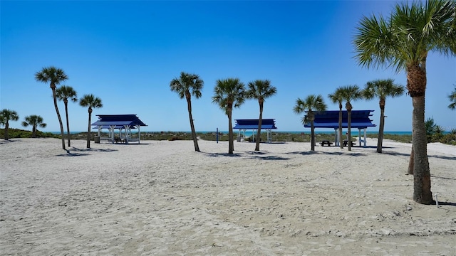 view of home's community with a beach view and a water view