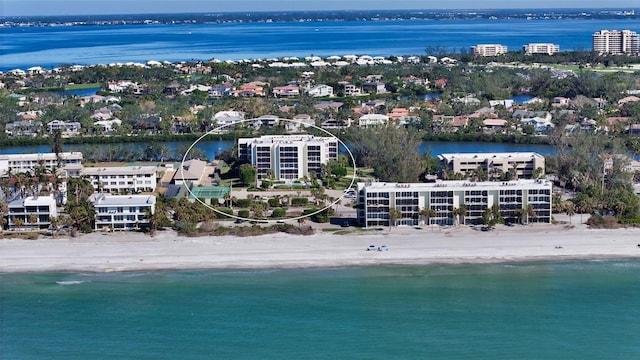 drone / aerial view with a beach view and a water view