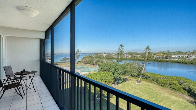 unfurnished sunroom featuring plenty of natural light and a water view