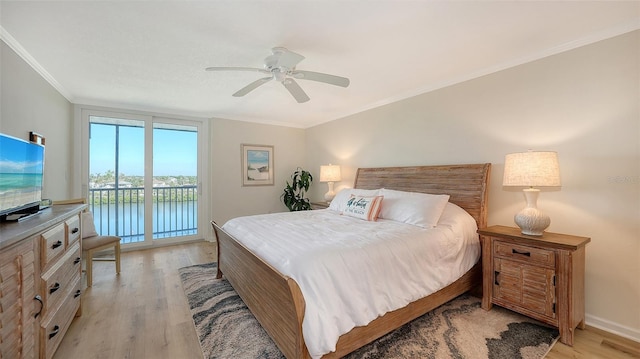 bedroom featuring access to outside, ceiling fan, light hardwood / wood-style flooring, and a water view