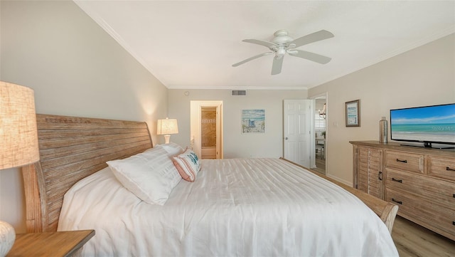 bedroom with connected bathroom, ceiling fan, light hardwood / wood-style flooring, and ornamental molding