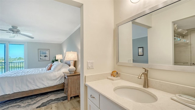 interior space featuring access to exterior, ceiling fan, sink, light hardwood / wood-style floors, and ornamental molding