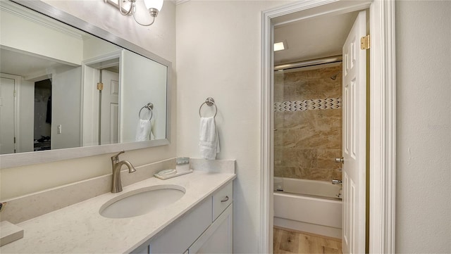 bathroom featuring shower / bath combination with glass door, vanity, and wood-type flooring